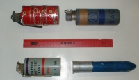 A variety of military-grade CS gas canisters. A ruler lies between them as a size reference. It is unclear if the FBI plans to use canisters similar to these in the Davidian assault.