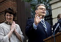 Senator-elect Al Franken (D-MN) acknowledges his victory in front of his Minneapolis home. His wife Franni Franken looks on.