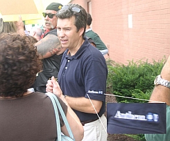 A protester at a health care forum wears a shirt from Anthem Blue Cross and Blue Shield, a prominent area health care provider.