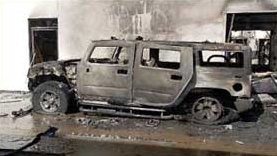 A burned Hummer at the vandalized West Covina dealership.