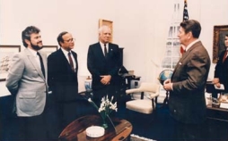 Reagan meets with Contra leaders in the Oval Office. NSC staffer and Contra “handler” Oliver North is at the far right; when this photo is released to the public, North will be cropped out.