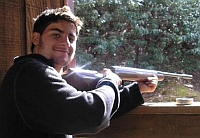 Joaquin Serrapio posing with one of his pellet guns. 