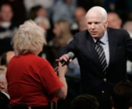 Presidential candidate John McCain takes the microphone from a woman who says opponent Barack Obama is ‘an Arab.’
