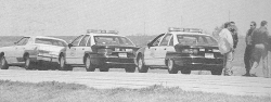 Timothy McVeigh’s Mercury Marquis and two Oklahoma state trooper vehicles, in a photo taken shortly after McVeigh was pulled over for not having a license plate.