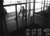 Security camera footage of the Ryder truck used by Timothy McVeigh to deliver the bomb as it is parked in front of the Murrah Federal Building just minutes before detonation. The truck is barely visible in the upper left of the frame.