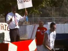 A tea party member masquerading as President Obama pretends to whip a ‘future taxpayer’ during a parade in Washington State.
