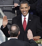 President-elect Barack Obama takes the oath of office as administered by Chief Justice John Roberts. His wife Michelle holds the Bible used to administer the oath, which will be redone the second day because of a minor error in Roberts’s delivery.