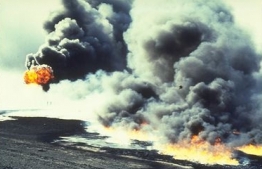 Oil spilled into the Persian Gulf is set afire.