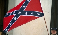 A protester holds a Confederate battle flag during a tea party rally in Olympia, Washington.