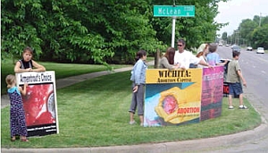 Anti-abortion protesters gather on a street corner in Wichita.