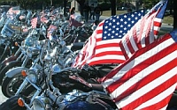 Members of the Patriot Guard Riders block Westboro Baptist Church protesters from the view of memorial proceedings in Joplin, Missouri.