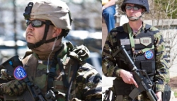 Some of the armed militia members gathering in support of Republican Senate candidate Rand Paul. The two depicted are wearing pro-Paul stickers.