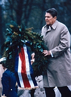 President Reagan places a wreath on a grave at Bitberg Cemetery.