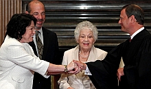 Sonia Sotomayor, left, is sworn in as a Supreme Court Justice by Chief Justice John Roberts, right. Her mother, Celina Sotomayor, and her brother, Juan Luis Sotomayor, look on.