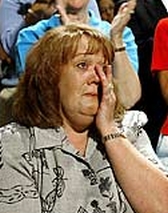 Tammy Pruett weeps while watching Bush’s presentation.