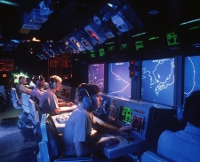 Crew members monitor radar screens in the combat information center aboard the <i>Vincennes.</i> This photo was taken by a crew member in January 1988.
