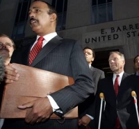 Lawyer Theodore Wells (left) speaks, while Lewis Libby and others look on. Libby is on crutches due to a recent foot injury.