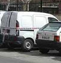 The white van, impounded in a police parking lot.