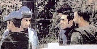 A surveillance photo of Shehzad Tanweer (second to the left), Mohammad Sidique Khan (far right), and Omar Khyam (center), taken in the parking lot of a McDonald’s restaurant on February 28, 2004. 