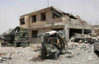 A blasted vehicle in front of the prison.