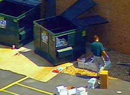 An FBI agent checking a dumpster near Steven Hatfill’s apartment.